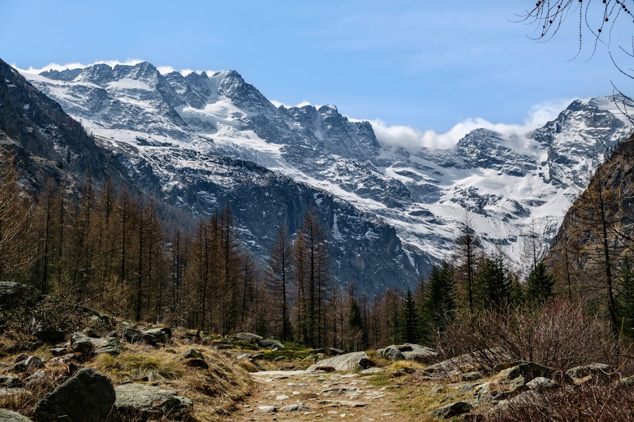 Breathtaking view of the snow-covered mountains in Aosta Valley under clear blue skies.
